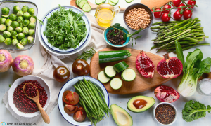 Various cut up and presented fruits and vegetables on a white table.